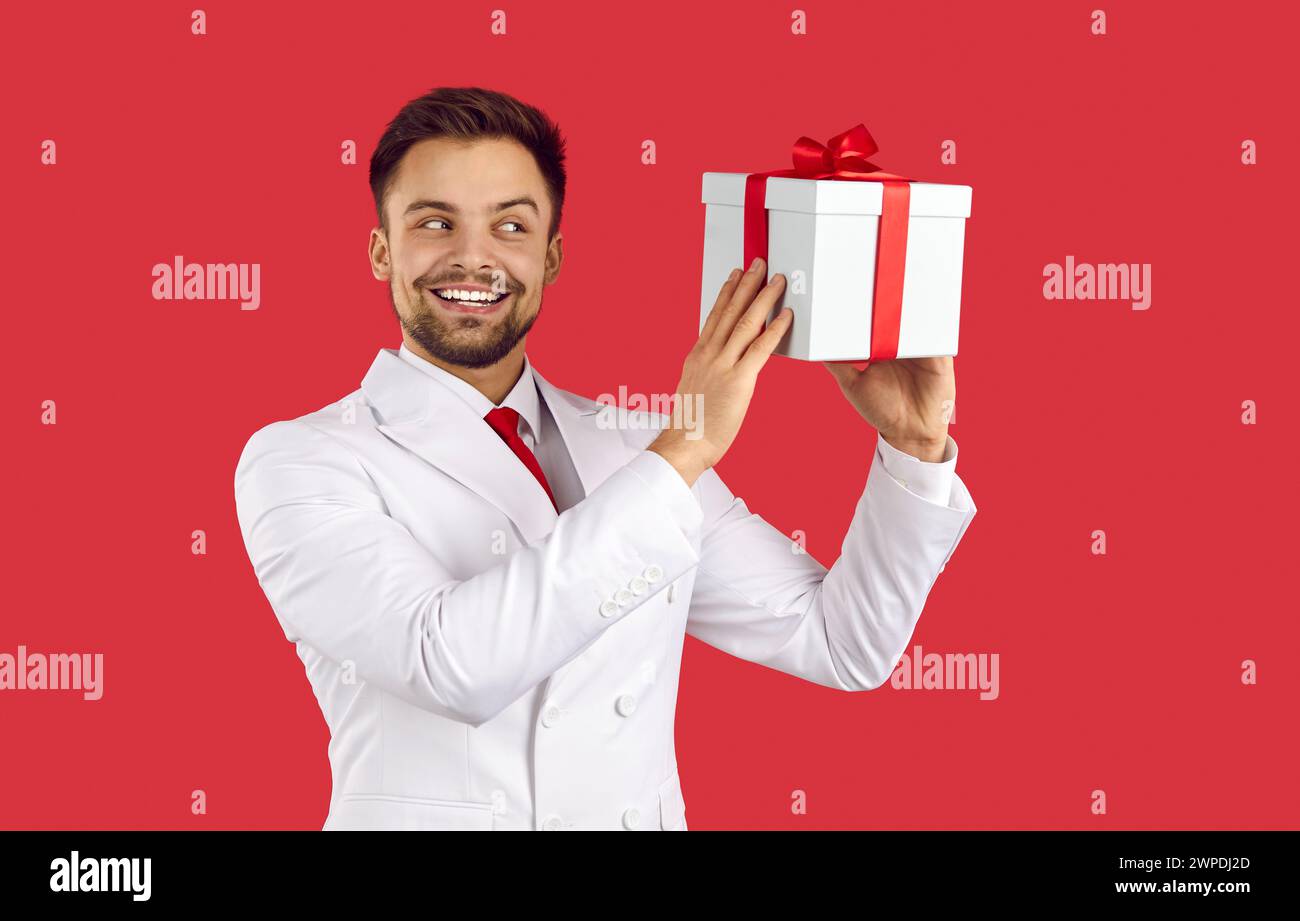 Smiling man in suit hold box greeting with special occasion Stock Photo