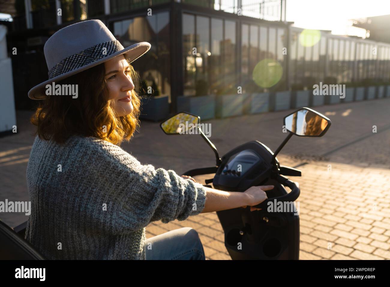 Woman tourist riding a four wheel mobility electric scooter on a city street.. Stock Photo
