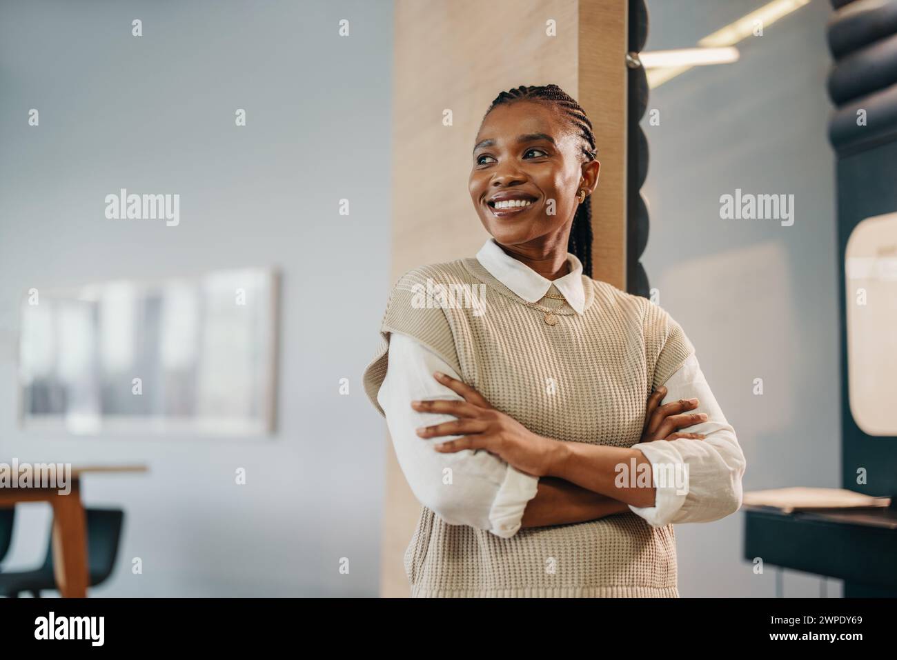 Happy and successful African businesswoman in a corporate office. She ...