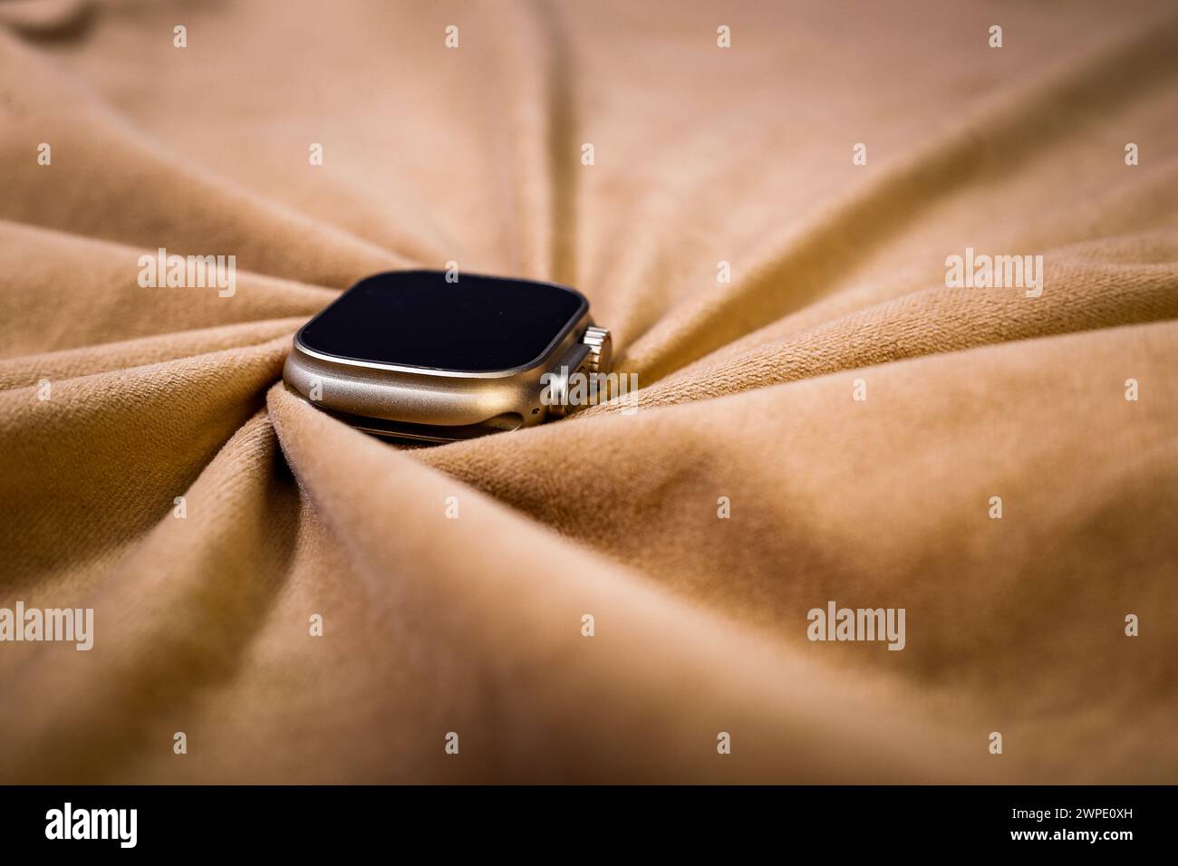 said angel view of Stylish smart watch covered by Brown color Cloth Stock Photo