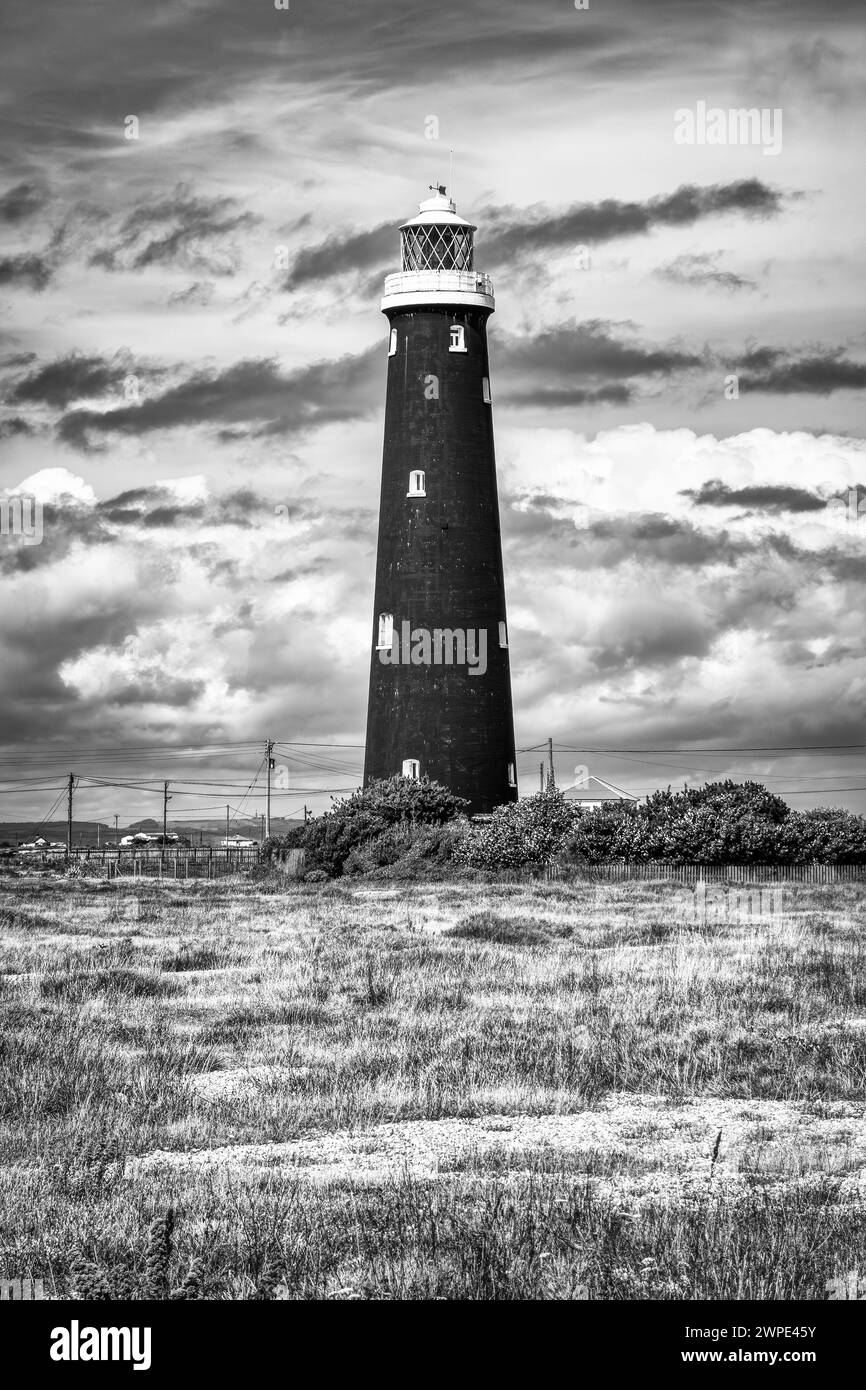 The Old Lighthouse, taken at Dungeness, Kent, in a Black & white HDR tone with dark moody clouds Stock Photo