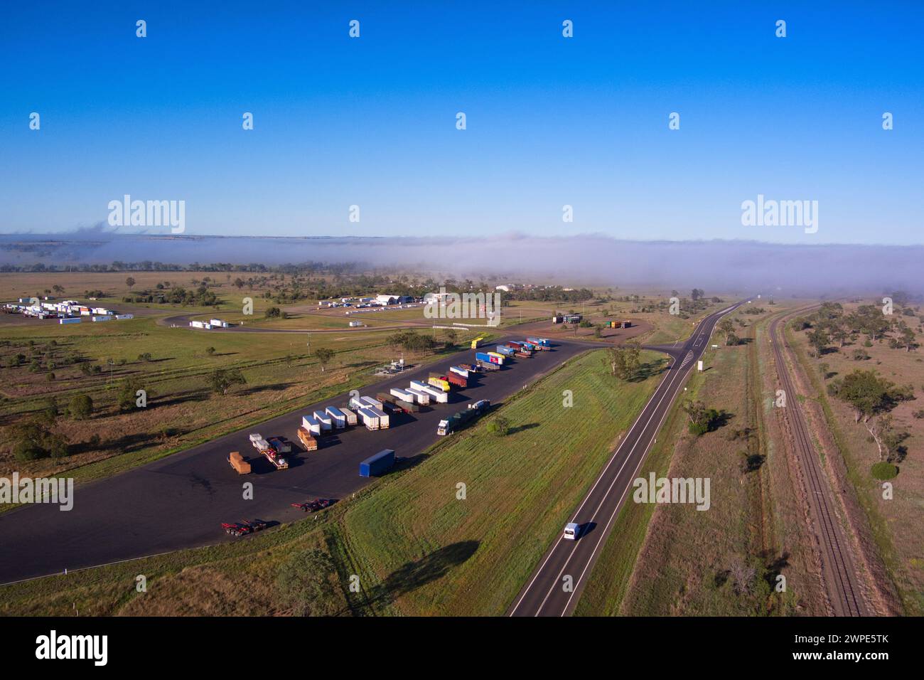 Aerial of roadtrain hook up and set down parking on the Warrego Highway Roma Queensland Australia Stock Photo