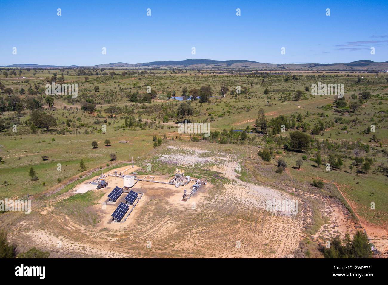 Aerial of coal seam gas (CSG) pumping well owned by Santos which can be a very profitable sideline for the farmer. Roma Queensland Australia Stock Photo