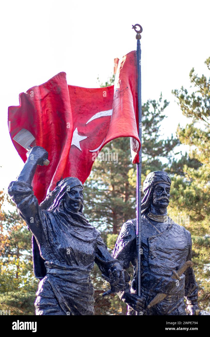 A statue of an Anatolian hero holding the Turkish flag high, alongside a female figure, 12 March 1918 symbolizing the liberation of Erzurum. Stock Photo