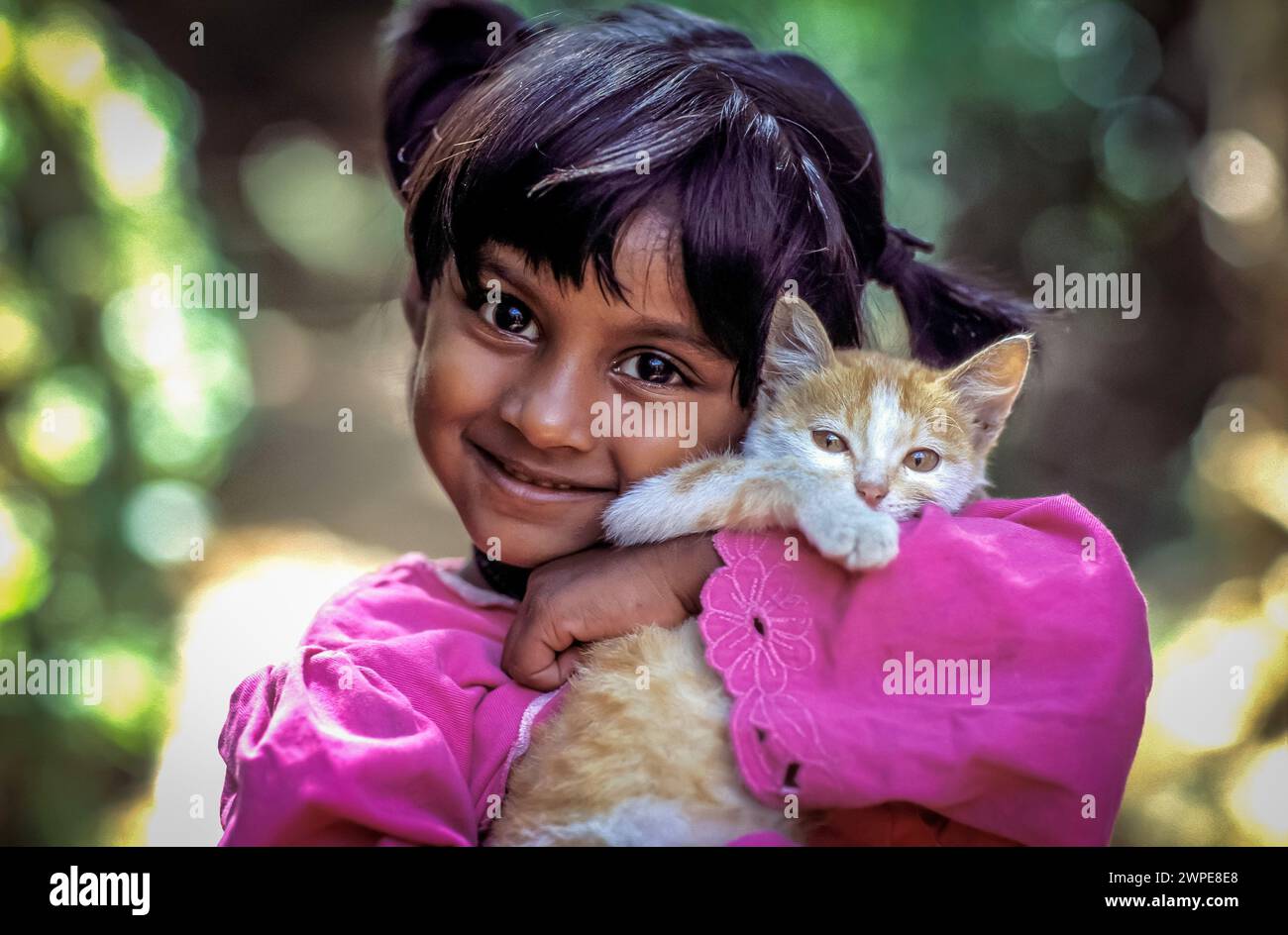 Sri Lanka, Polonaruwa; girl is holding a kitten in her arms Stock Photo ...