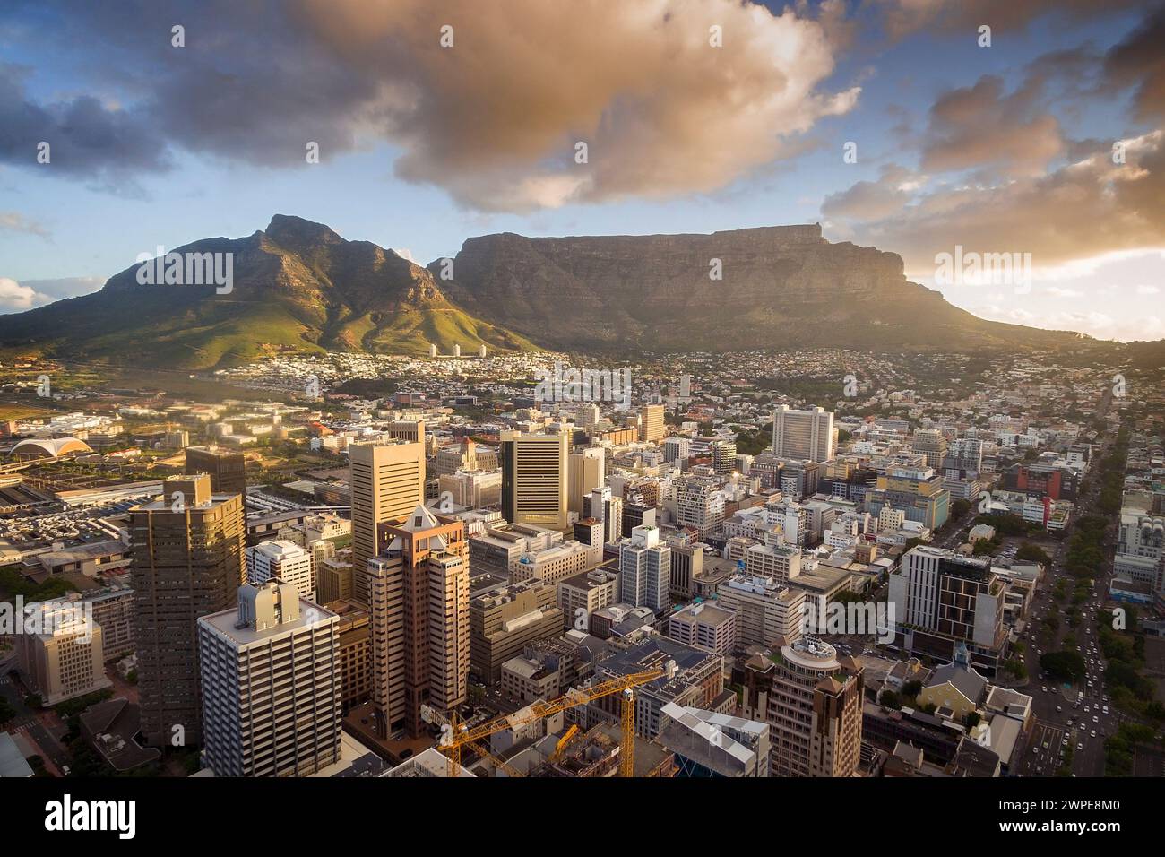 An aerial view of Cape Town central business district in late afternoon as the sun is setting, showing Table Mountain. Stock Photo