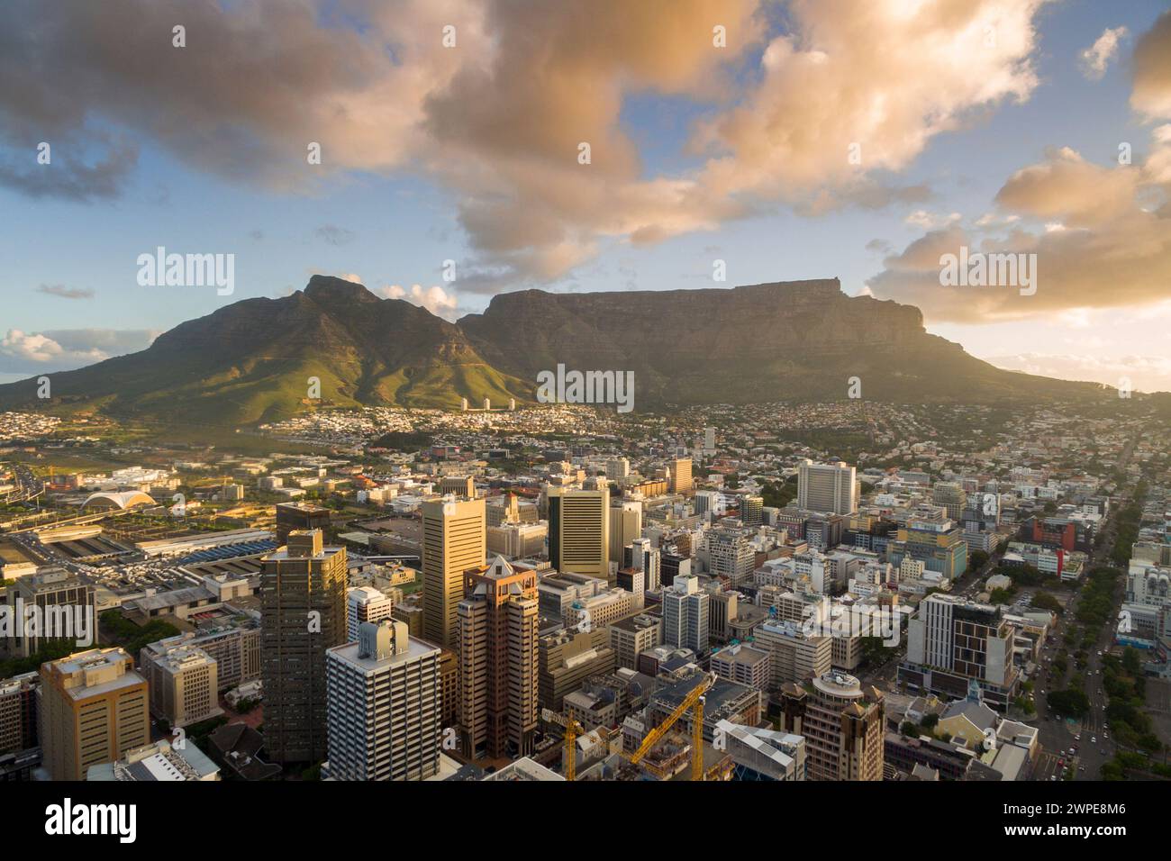 An aerial view of Cape Town central business district in late afternoon as the sun is setting, showing Table Mountain. Stock Photo