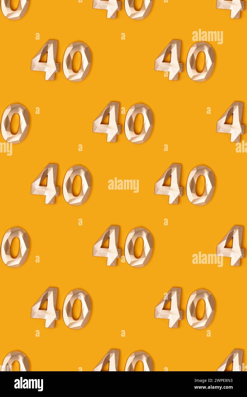 Pattern made of golden number 40 on a yellow background. Stock Photo