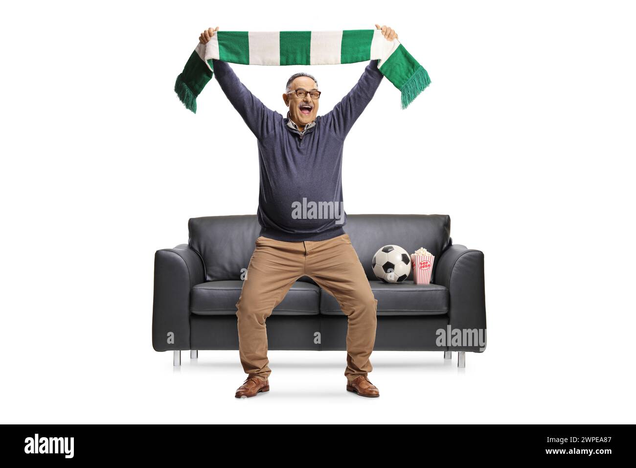 Full length portrait of a happy mature man cheering with a scarf in ...