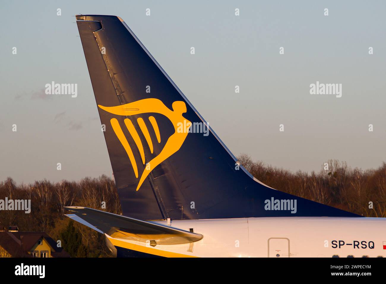 Irish low-cost airline's Ryanair Boeing 737-800 vertical stabilizer close-up while taxiing at Lviv Airport during golden hour Stock Photo