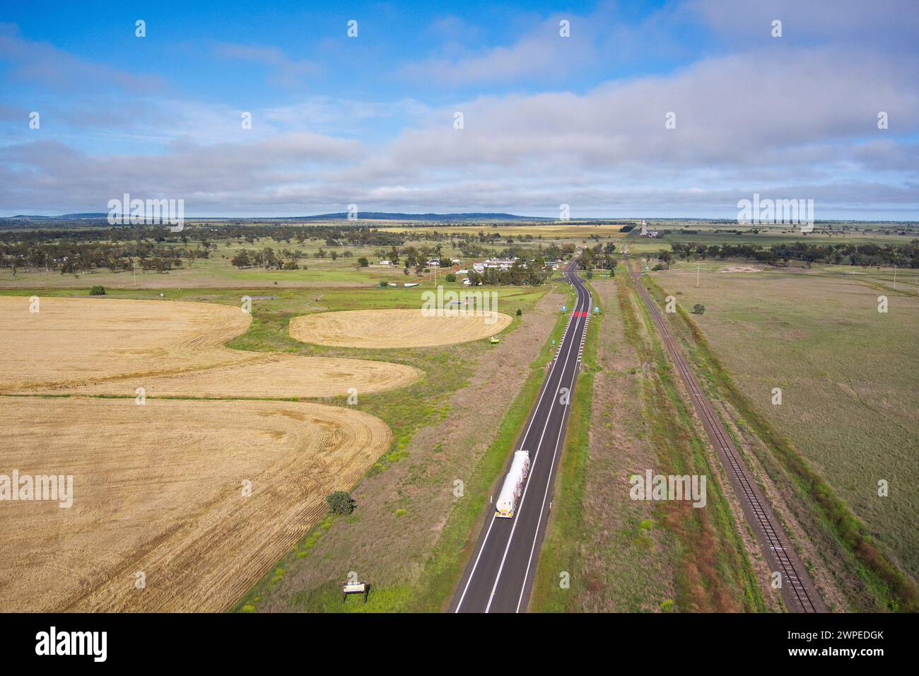 Aerial of road train travelling along the Warrego Highway into Muckadilla Queensland Australia Stock Photo