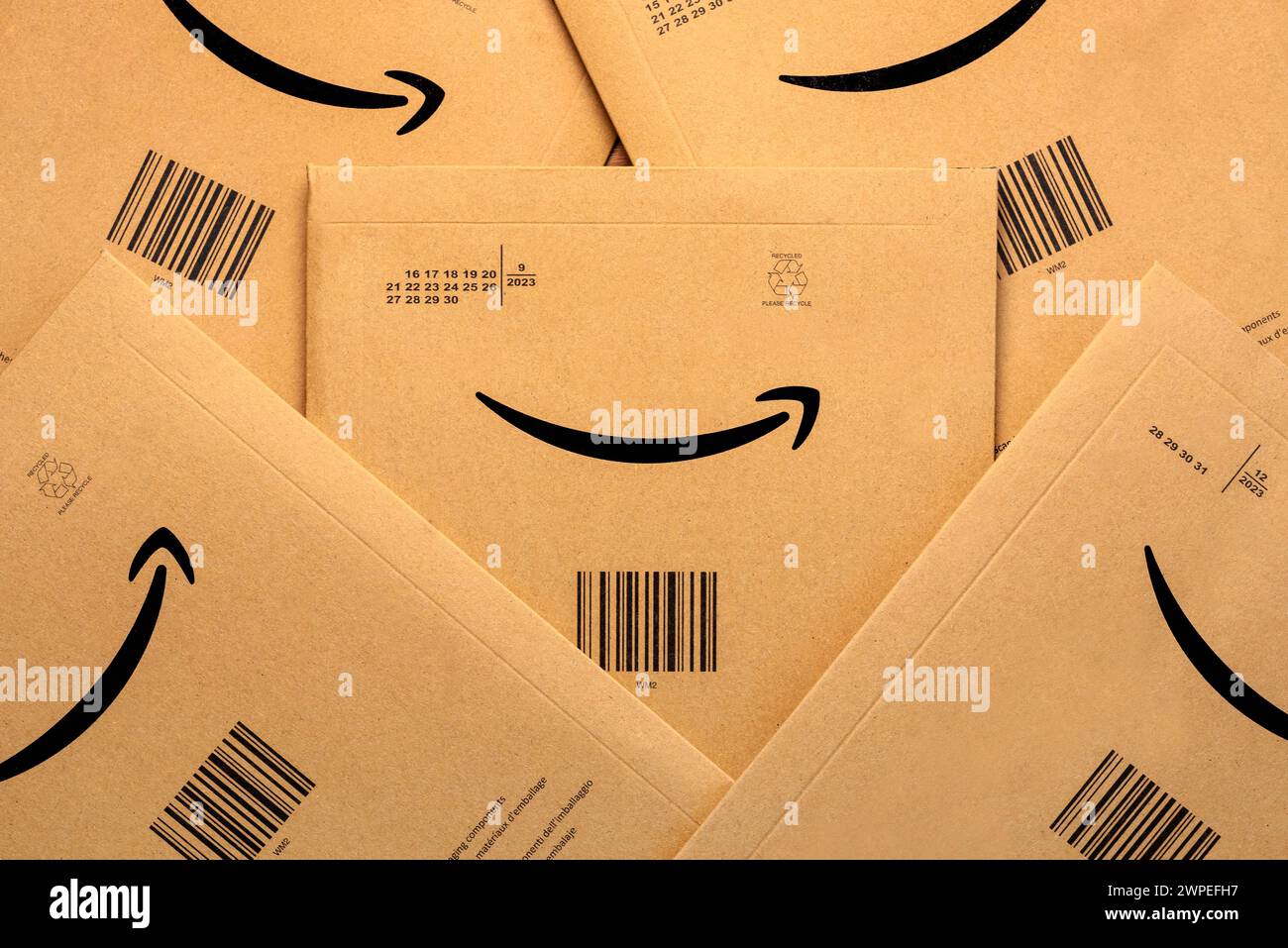 Closeup of Amazon Prime cardboard boxes and Amazon logo. Amazon prime parcel delivery. Illustrative editorial Stock Photo