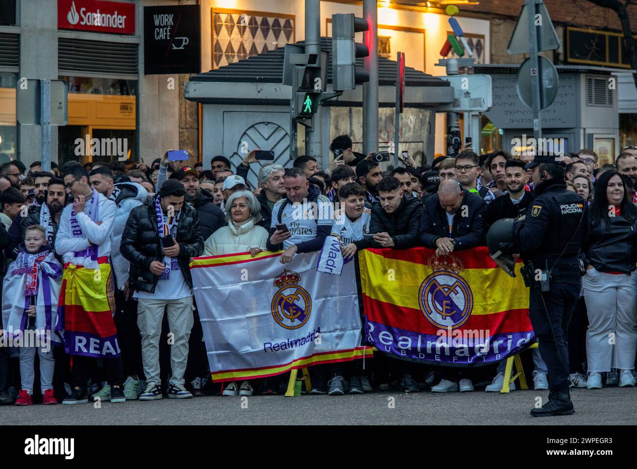 Madrid, Spain. 06th Mar, 2024. A group of Real Madrid fans wait for the arrival of the Madrid team bus with flags and scarves outside the Santiago Bernabeu stadium. Real Madrid faced the German R. B. Leipzig tonight at the Santiago Bernabeu stadium in the round of 16 of the Uefa Champions League. Credit: SOPA Images Limited/Alamy Live News Stock Photo