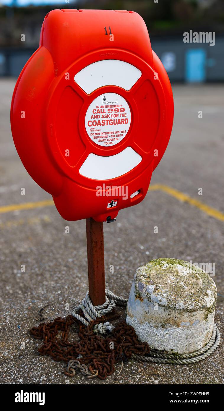 Lifebuoy Rescue housing in Red with Coastguard contact details for emergency in order to save lives Stock Photo