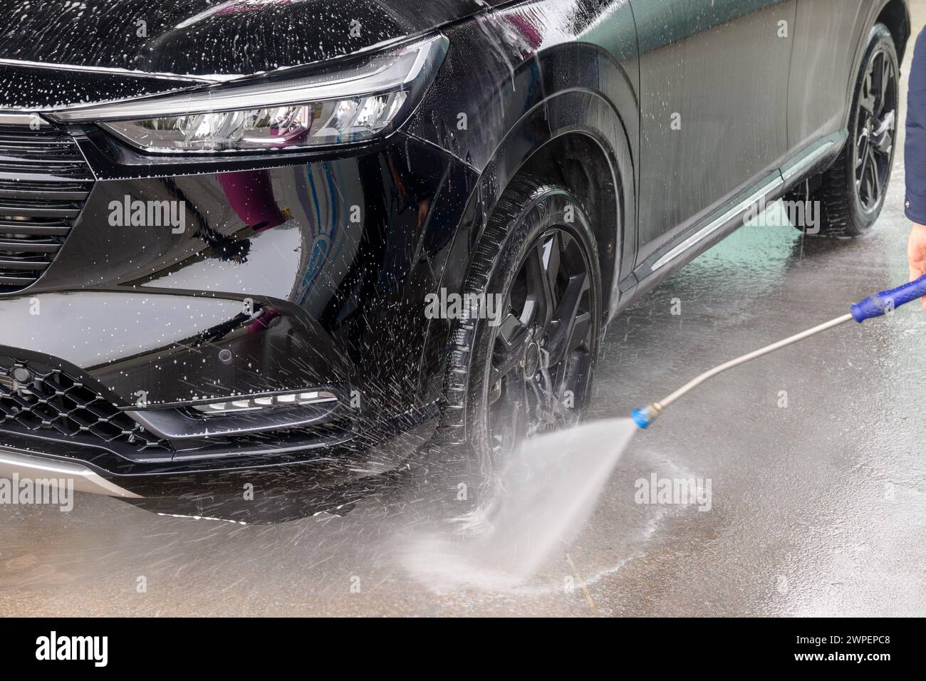 Manual car wash with pressurized water in car wash outside Stock Photo