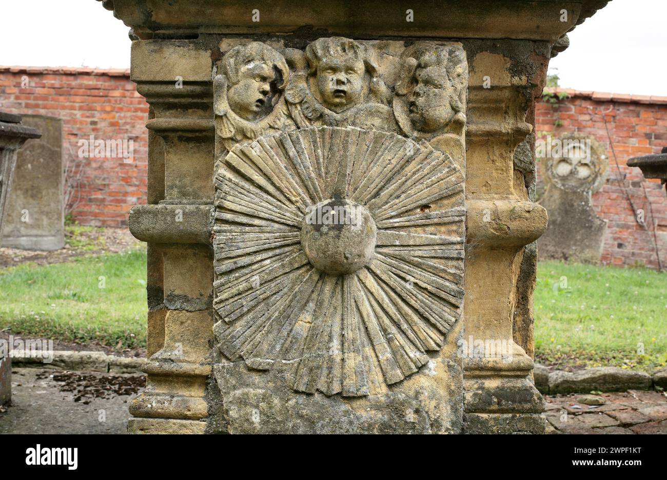 A carved sunflower motif on a tomb in the churchyard of St Peter's Church, Stretton-on-Fosse, Warwickshire. Stock Photo