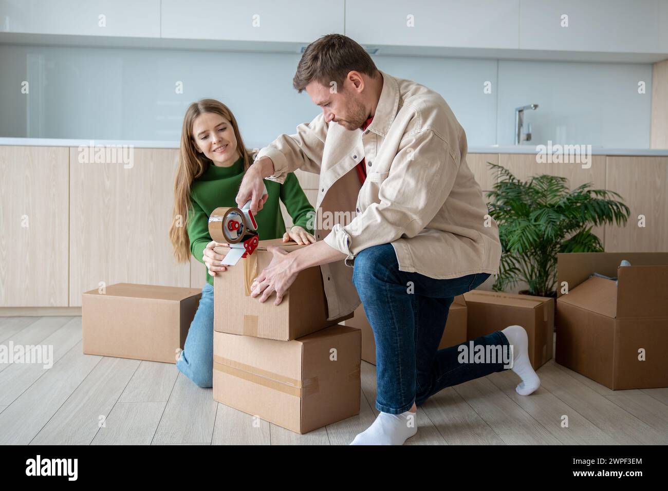 Woman packing moving box hi-res stock photography and images - Alamy