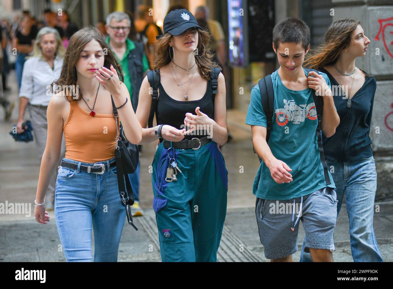 Italian young friends walking in Via Ugo Bassi, Bologna, Italy. Stock Photo