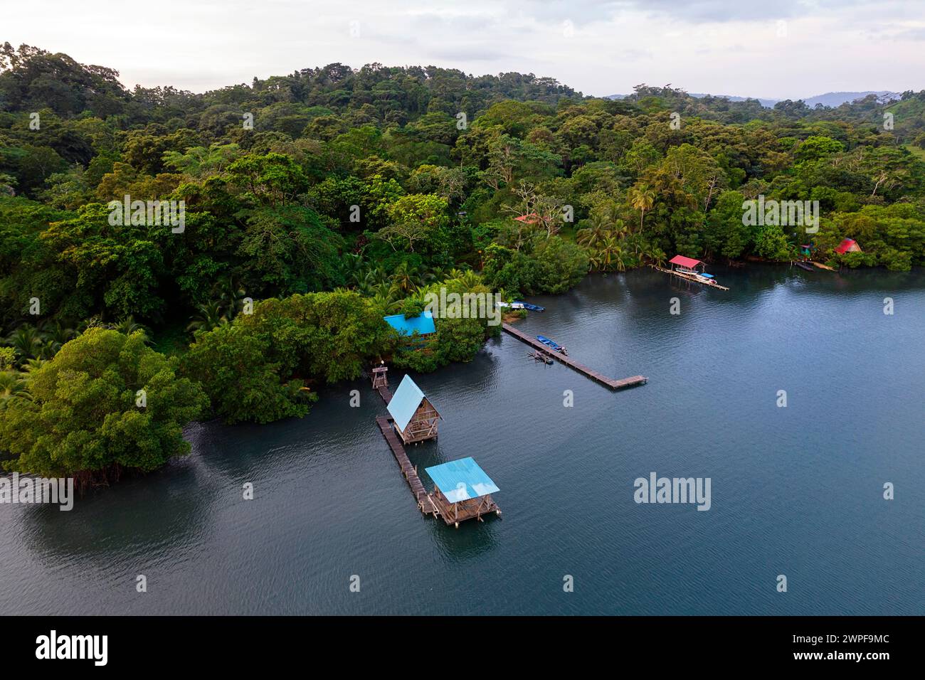 Aerial view of a beautiful tourist wooden cabin over the water in Dolphin Bay on the Island Isla San Cristobal, Bocas del toro, Panama Stock Photo