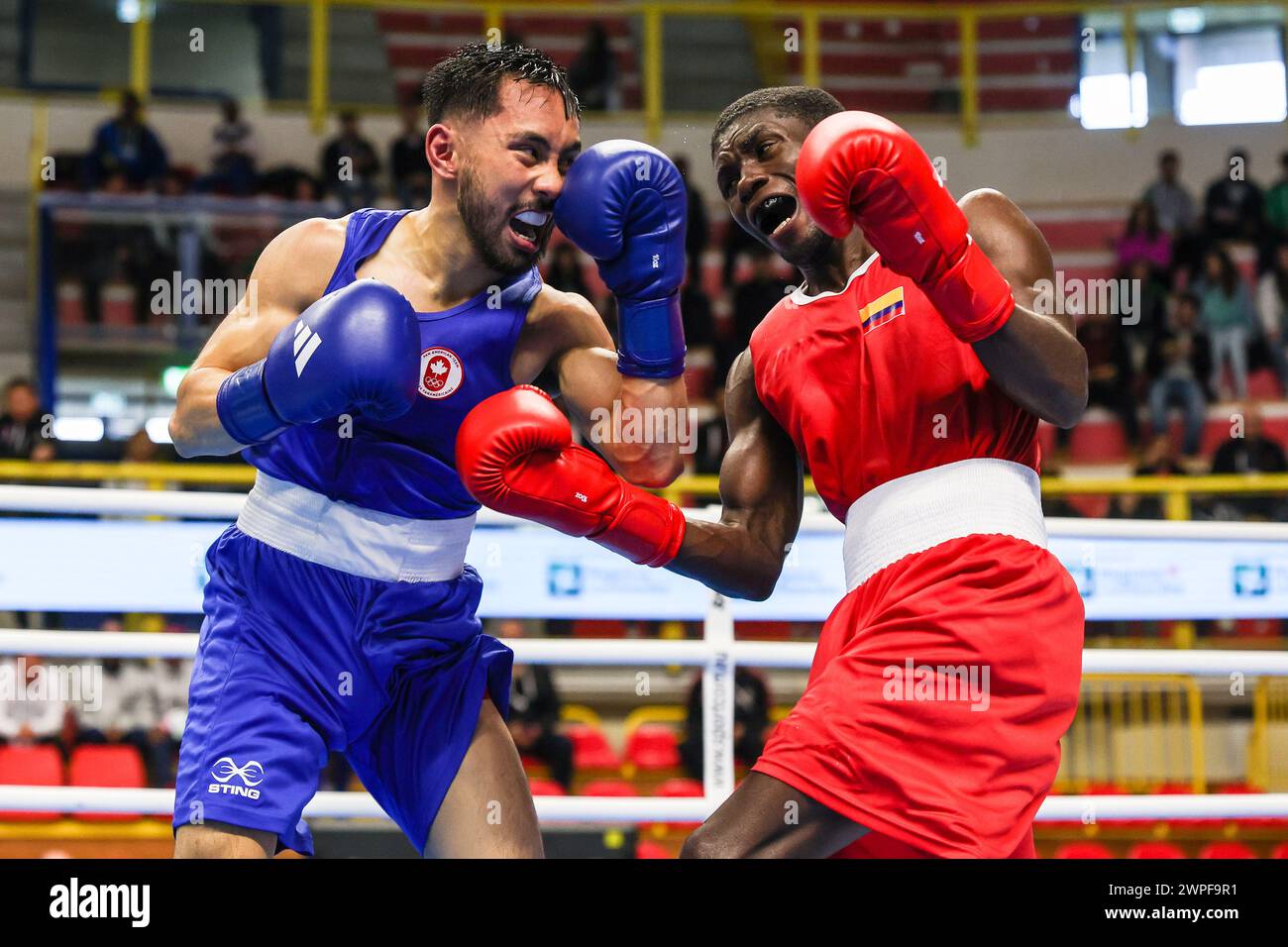 Yuberjen Martinez Rivas (Red) of Colombia in action against Justin John Sitchon Parina (Blue) of Canada during the 1st World Qualifying Tournament Boxing Road to Paris fight between Yuberjen Martinez Rivas (Red) of Colombia and Justin John Sitchon Parina (Blue) of Canada at E-Work Arena. Stock Photo