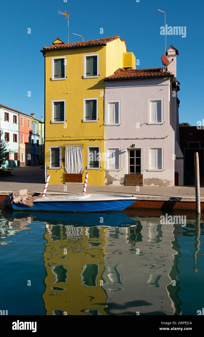 Brightly coloured houses by the edge of the canal at Burano, Venetian Lagoon, northern Italy, Stock Photo