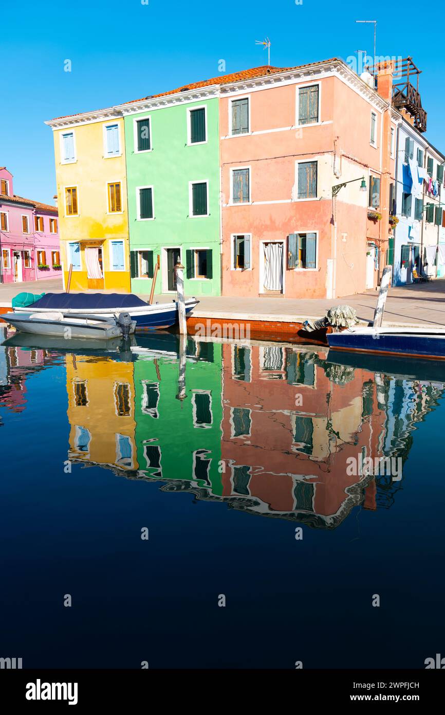 Brightly coloured houses by the edge of the canal at Burano, Venetian Lagoon, northern Italy, Stock Photo
