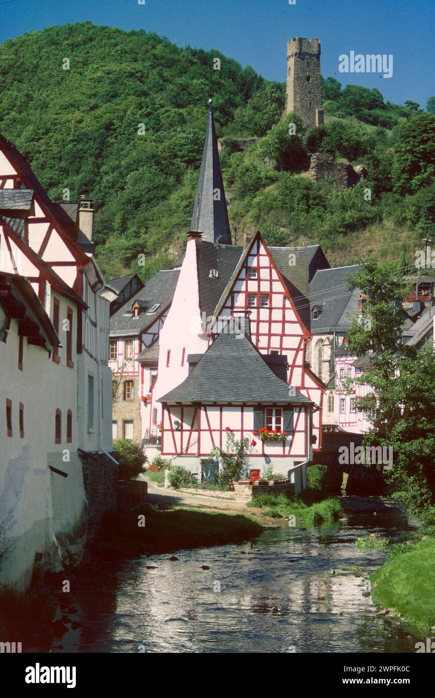 Half-timbered houses and church spire beside the Elzbach River in 1980, Monreal, Rhineland Palatinate, Germany Stock Photo