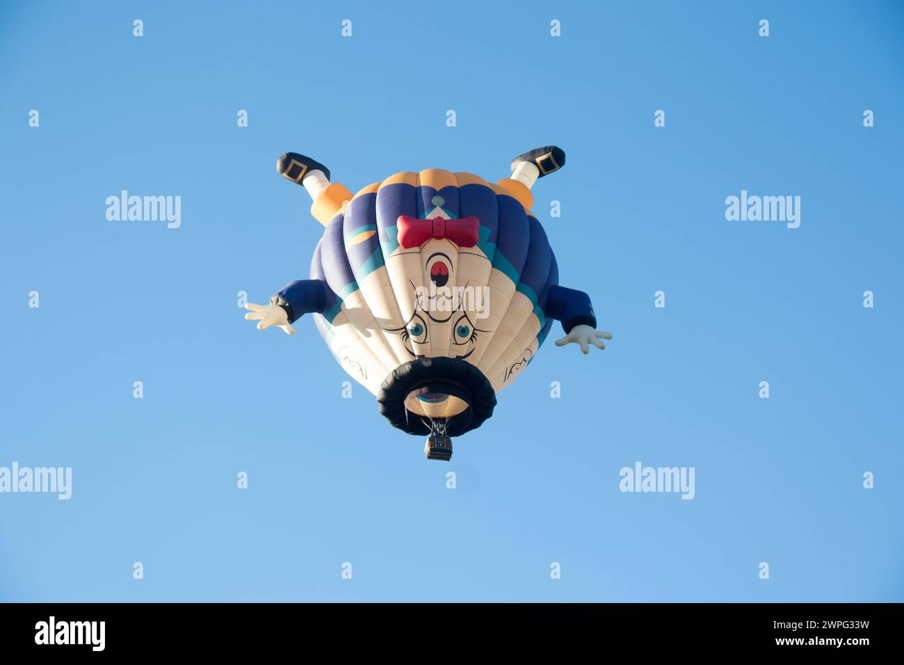 Funny, humorous hot air balloon of Humpty Dumpty nursery rhyme flying against blue sky in  Albuquerque, New Mexico. Stock Photo