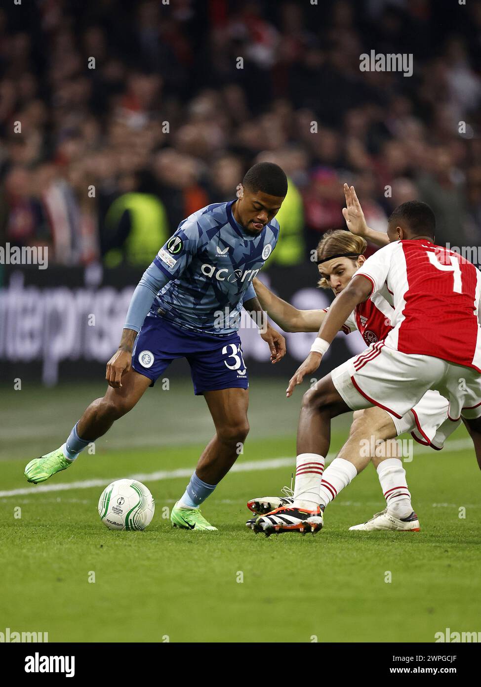 AMSTERDAM - (l-r) Leon Bailey of Aston Villa FC, Borna Sosa of Ajax, Jorrel Hato of Ajax during the UEFA Conference League round of 16 match between Ajax Amsterdam and Aston Villa FC at the Johan Cruijff ArenA on March 7, 2024 in Amsterdam, Netherlands. ANP | Hollandse Hoogte | MAURICE VAN STEEN Stock Photo