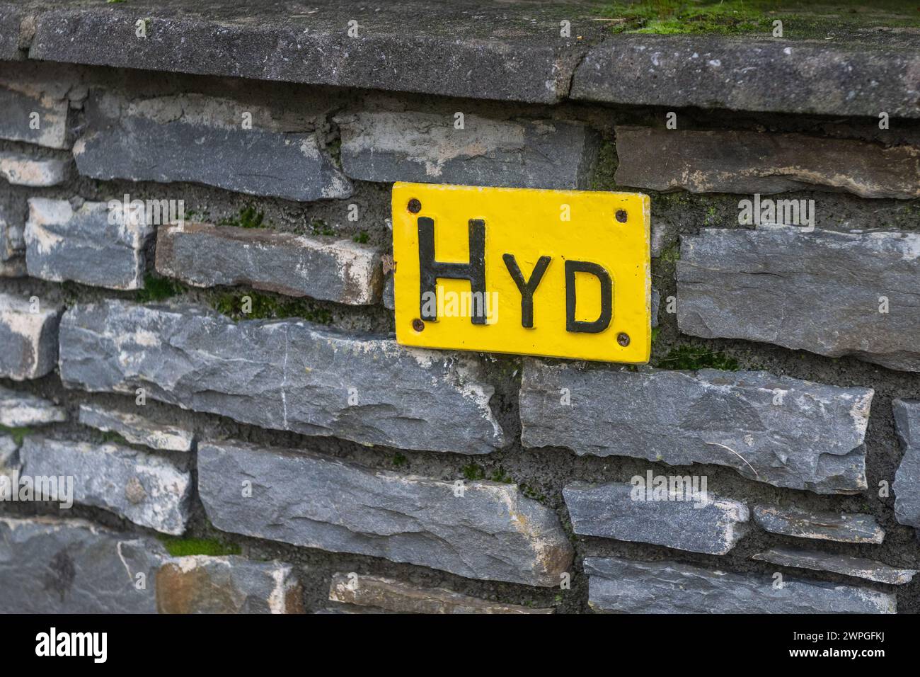 Sign on wall indicating the location of the nearest fire hydrant, Ireland. Stock Photo