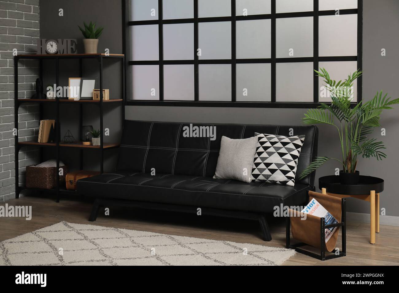 Stylish interior of modern living room with black sofa Stock Photo - Alamy