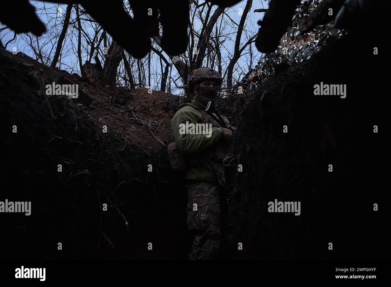 Kyiv, Donetsk Oblast, Ukraine. 7th Mar, 2024. Vlad, a Ukrainian solider observes the frontline from a Ukrainian trench. Russian infantry positions are 100m away from Ukrainian lines. (Credit Image: © Madeleine Kelly/ZUMA Press Wire) EDITORIAL USAGE ONLY! Not for Commercial USAGE! Stock Photo