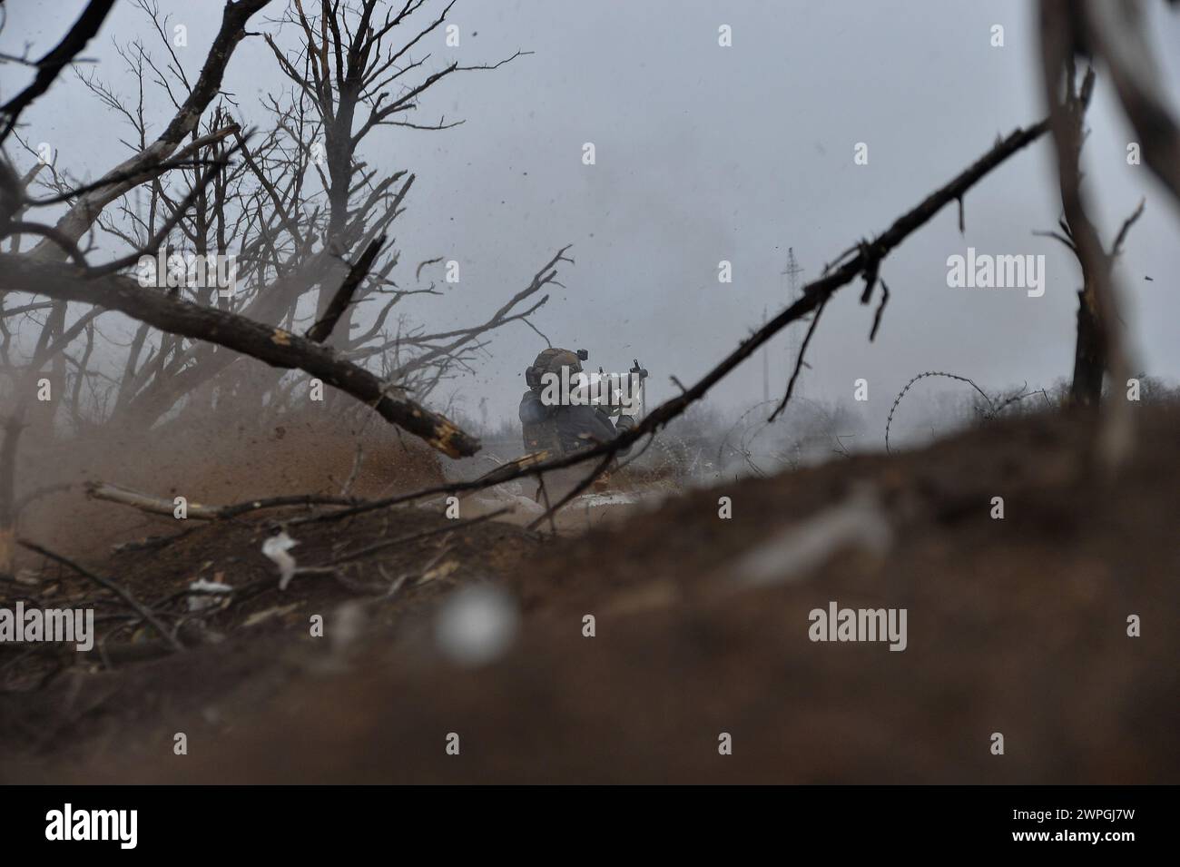 Kyiv, Donetsk Oblast, Ukraine. 7th Mar, 2024. Zhenya, a Ukrainian solider, fires an RPG at Russian lines 100 meters away. Russian infantry positions are 100m away from Ukrainian lines. (Credit Image: © Madeleine Kelly/ZUMA Press Wire) EDITORIAL USAGE ONLY! Not for Commercial USAGE! Stock Photo