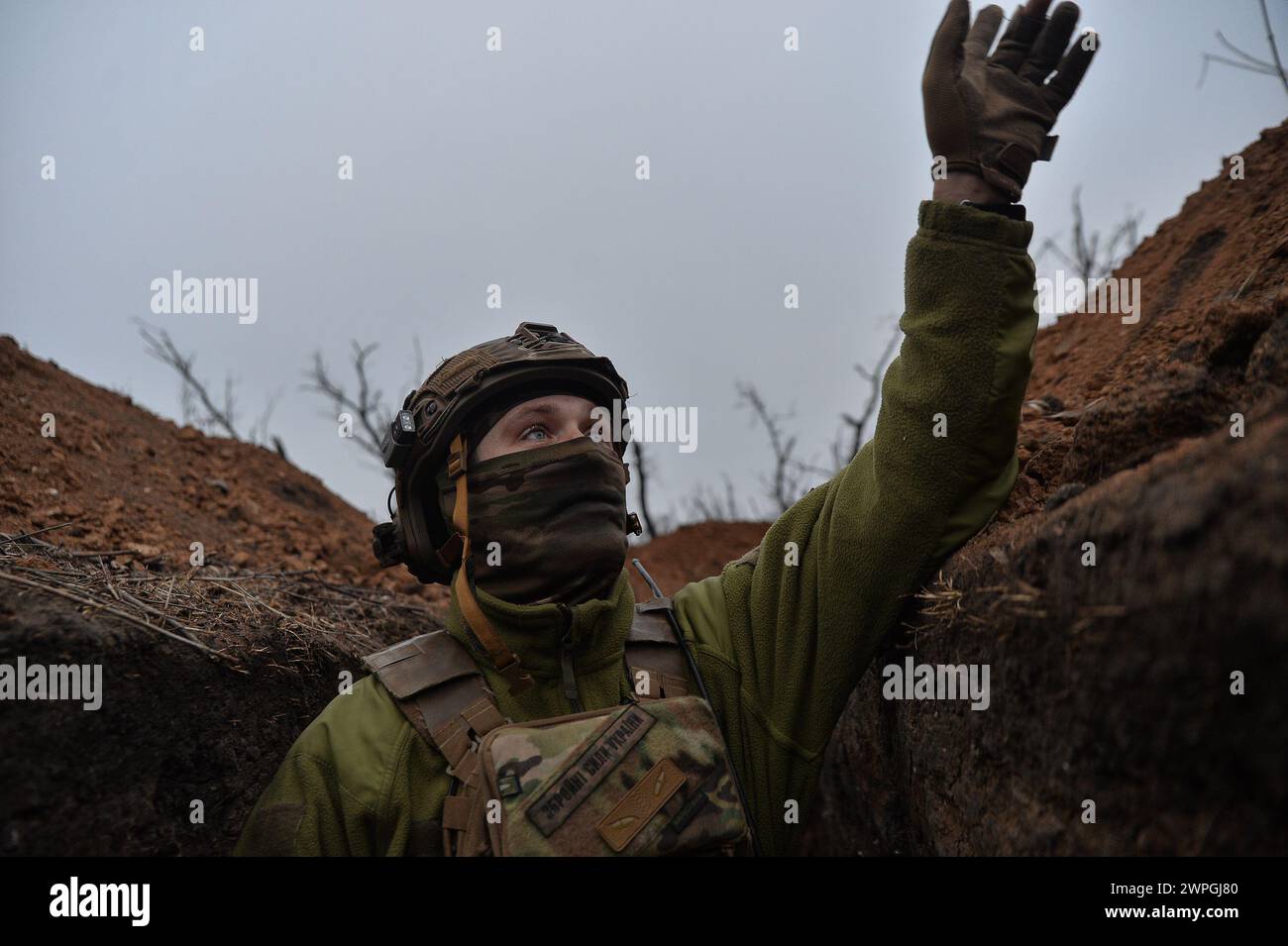 Kyiv, Donetsk Oblast, Ukraine. 7th Mar, 2024. Vlad, a Ukrainian solider points towards Russian lines looking for enemy drones. Russian infantry positions are 100m away from Ukrainian lines. (Credit Image: © Madeleine Kelly/ZUMA Press Wire) EDITORIAL USAGE ONLY! Not for Commercial USAGE! Stock Photo
