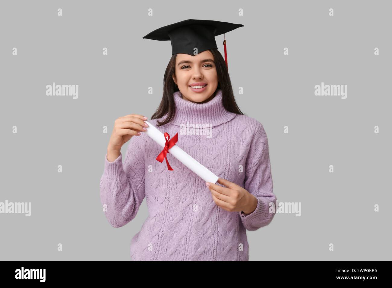 Happy smiling female student in graduation hat with diploma on white ...