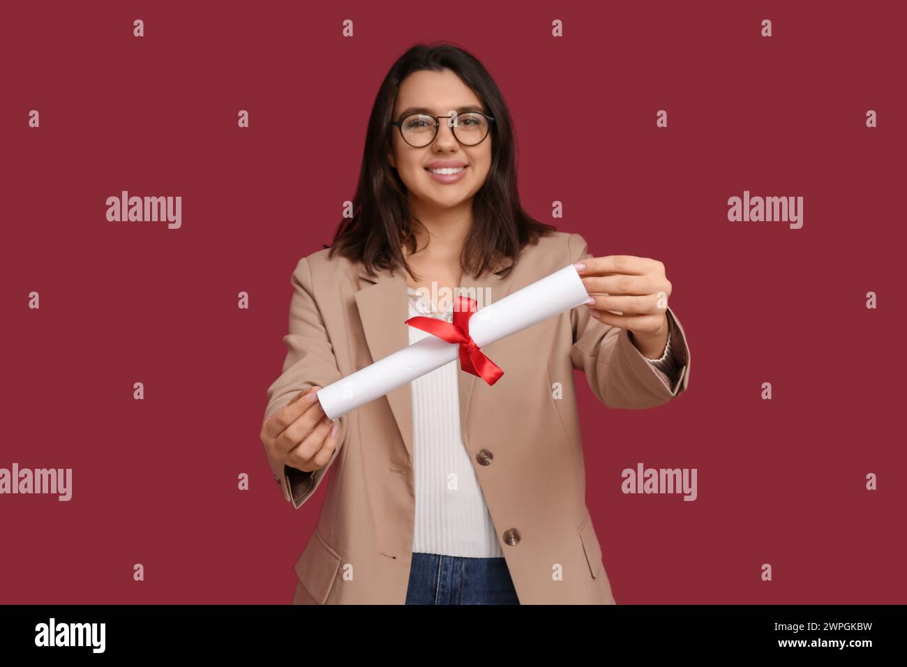 Happy smiling female student with diploma on red background Stock Photo ...