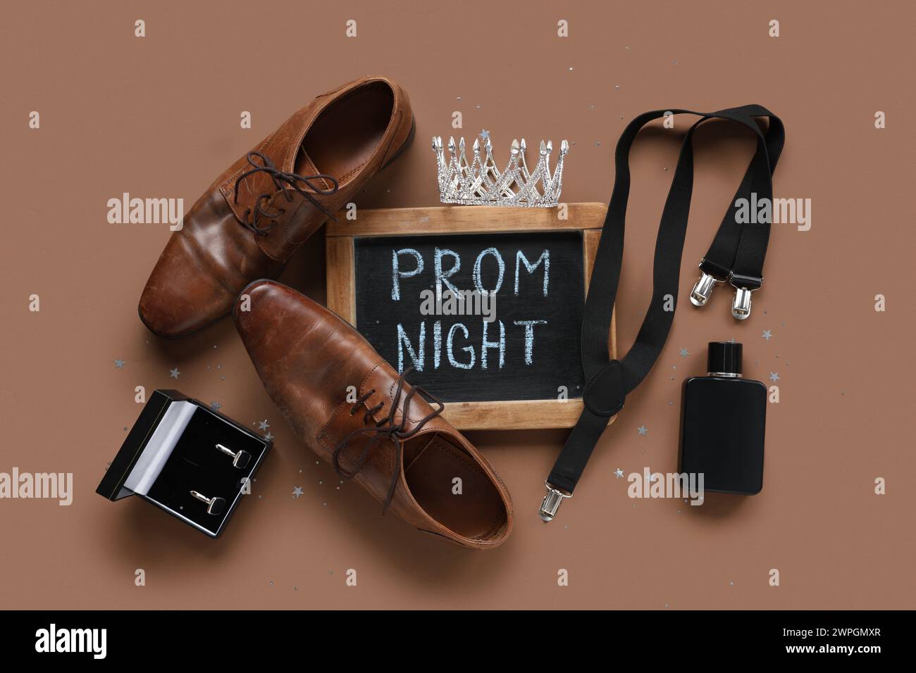 Chalkboard with text PROM NIGHT, male shoes and suspender on brown background Stock Photo