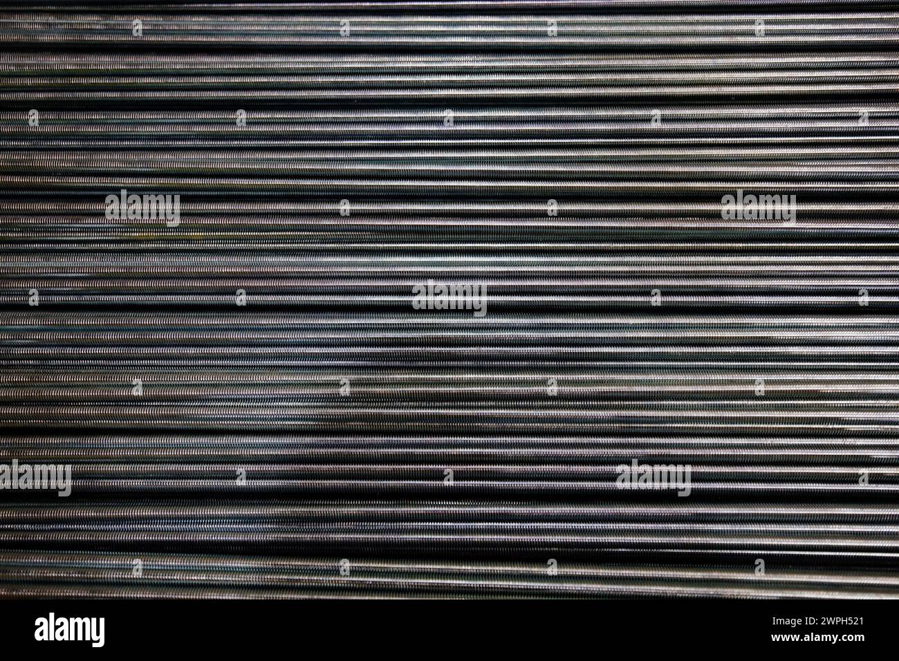 Group of threaded steel rods, abstract background. Stock Photo