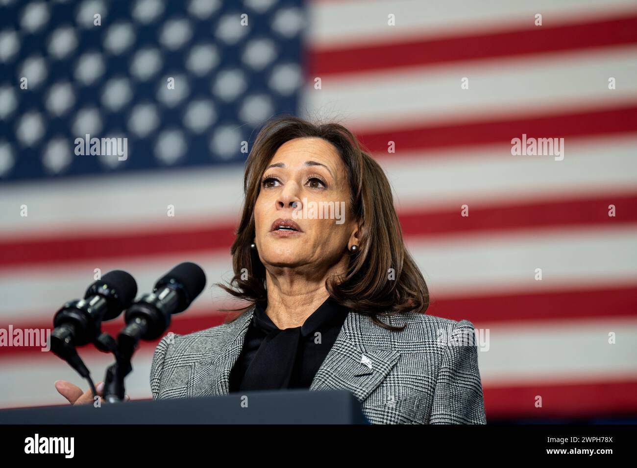 United States Vice President Kamala Harris gives a speech with the American Flag filling the frame in the background Stock Photo