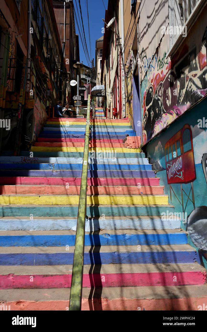 Rainbow coloured steps leading upwards between buildings. Stock Photo
