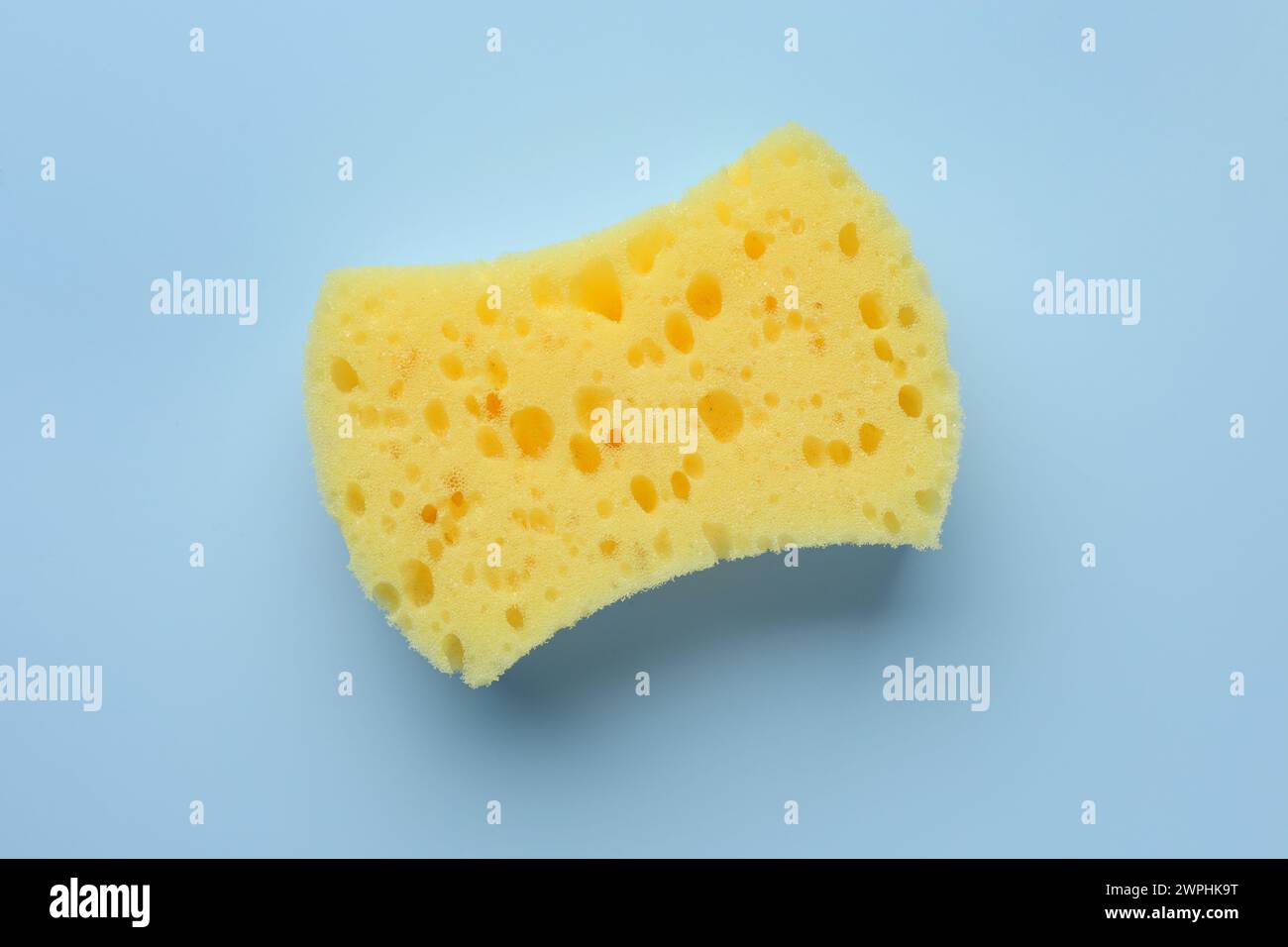 New yellow sponge on light blue background, top view Stock Photo - Alamy