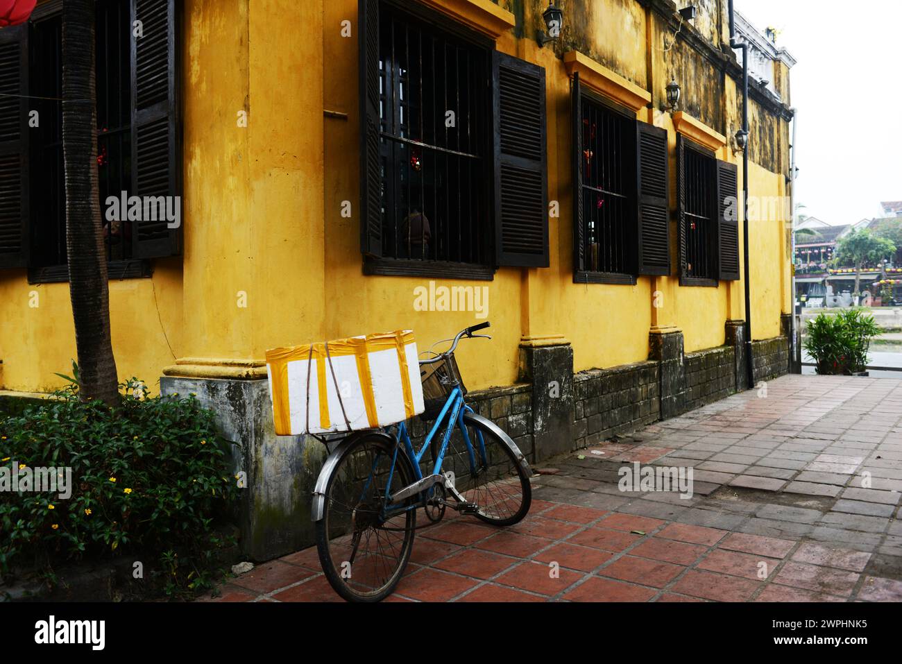 A bicycle by a beautiful old building in the old city of Hoi An, Vietnam. Stock Photo