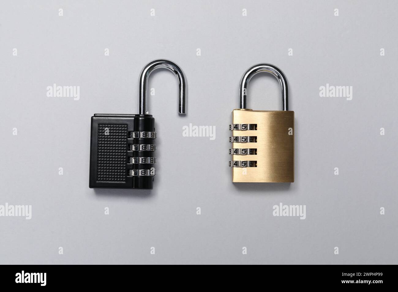 Steel combination padlocks on grey background, top view Stock Photo