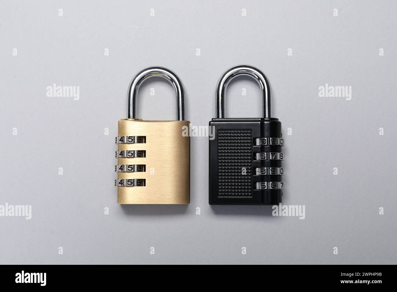 Steel combination padlocks on grey background, top view Stock Photo