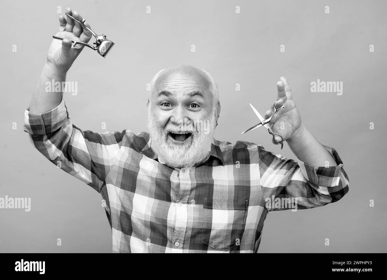 Excited barber scissors and straight razor hair clipper, Vintage barber shop, shaving. Portrait old bearded man. Vintage barbershop. Stock Photo