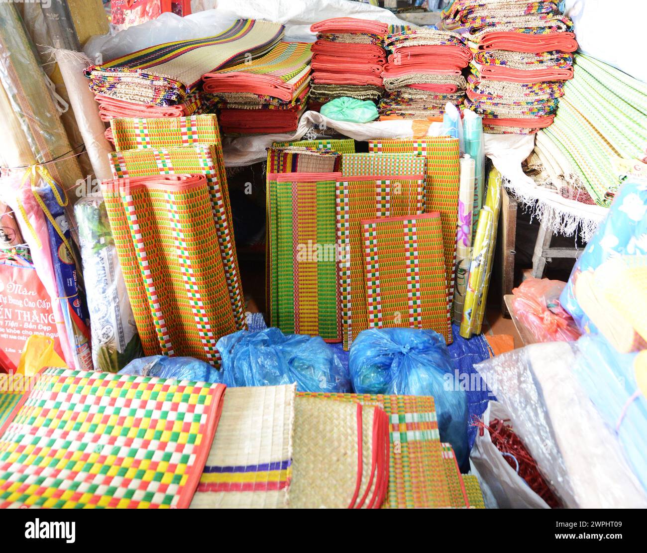 Traditional floor mats displayed by a souvenir shop in the old city of Hoi An, Vietnam. Stock Photo