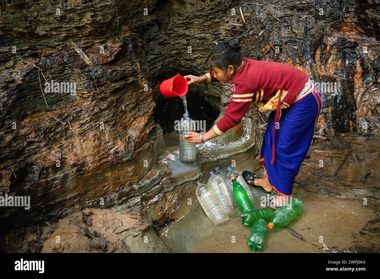 Bandarban, Bangladesh. 17th Jan, 2024. A Mro woman fetches drinking water from a mountain spring. Mro people are an indigenous ethnic group in Bangladesh. They primarily inhabit the Chittagong Hill Tracts (CHT) region, which includes districts such as Bandarban, Rangamati, and Khagrachari. The Mro people are one of the many indigenous communities in Bangladesh, and they have a distinct cultural identity, language, and traditional way of life. (Photo by Piyas Biswas/SOPA Images/Sipa USA) Credit: Sipa USA/Alamy Live News Stock Photo