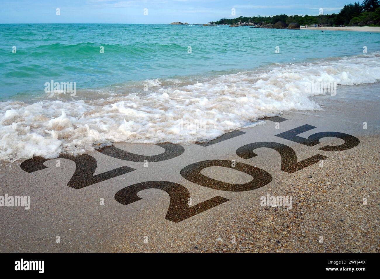 Beautiful beach waves wash away 2024 towards the new year 2025 Stock Photo