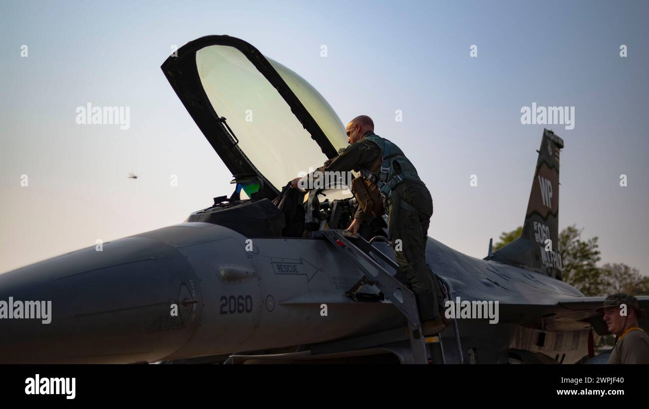 Col. Matthew “Wolf 64” Gaetke, 8th Fighter Wing commander, steps into an F-16 Fighting Falcon to participate in Joint Exercise Cobra Gold 24 Stock Photo