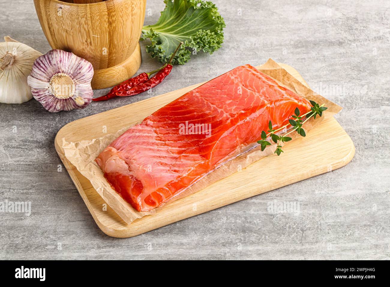 Raw salmon fillet piece over board Stock Photo - Alamy